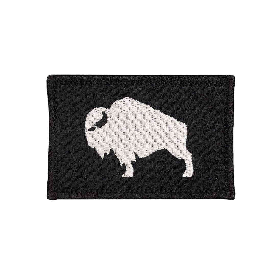 An embroidered patch of a buffalo on black canvas