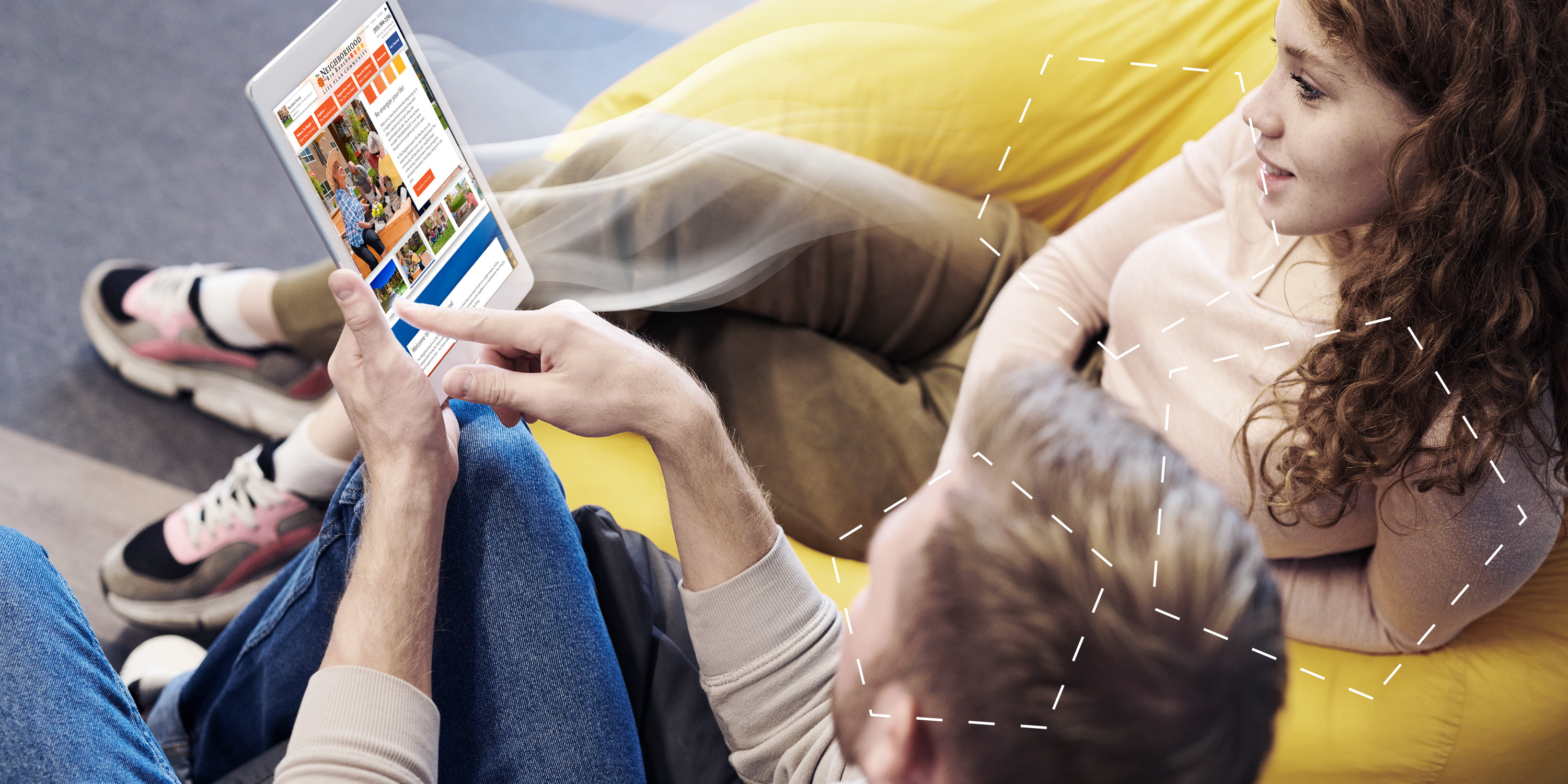 Two people browsing a website on a tablet